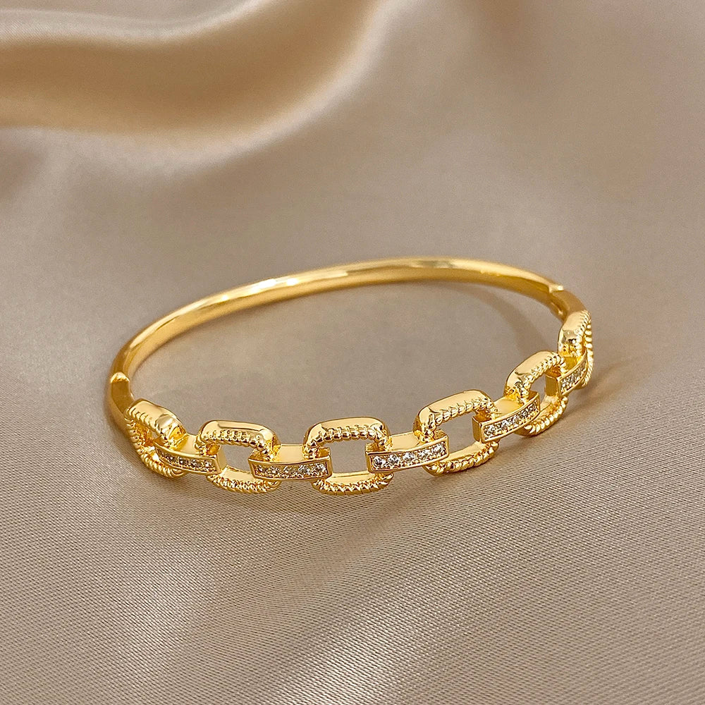 Gold-tone square-link bracelet with clear zircon insets, glossy chain-style cuff