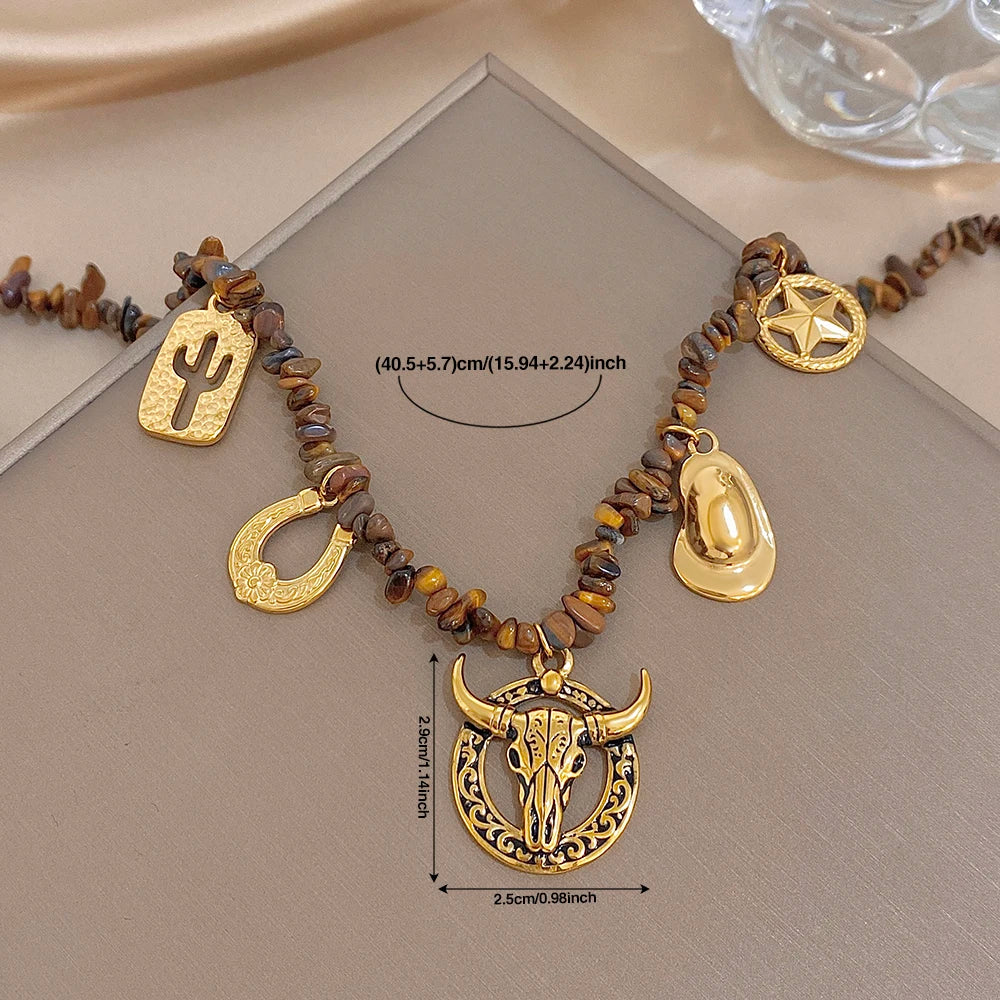 Gold-tone charm beaded necklace with bull head pendant, cactus, star disc, and teardrop charms