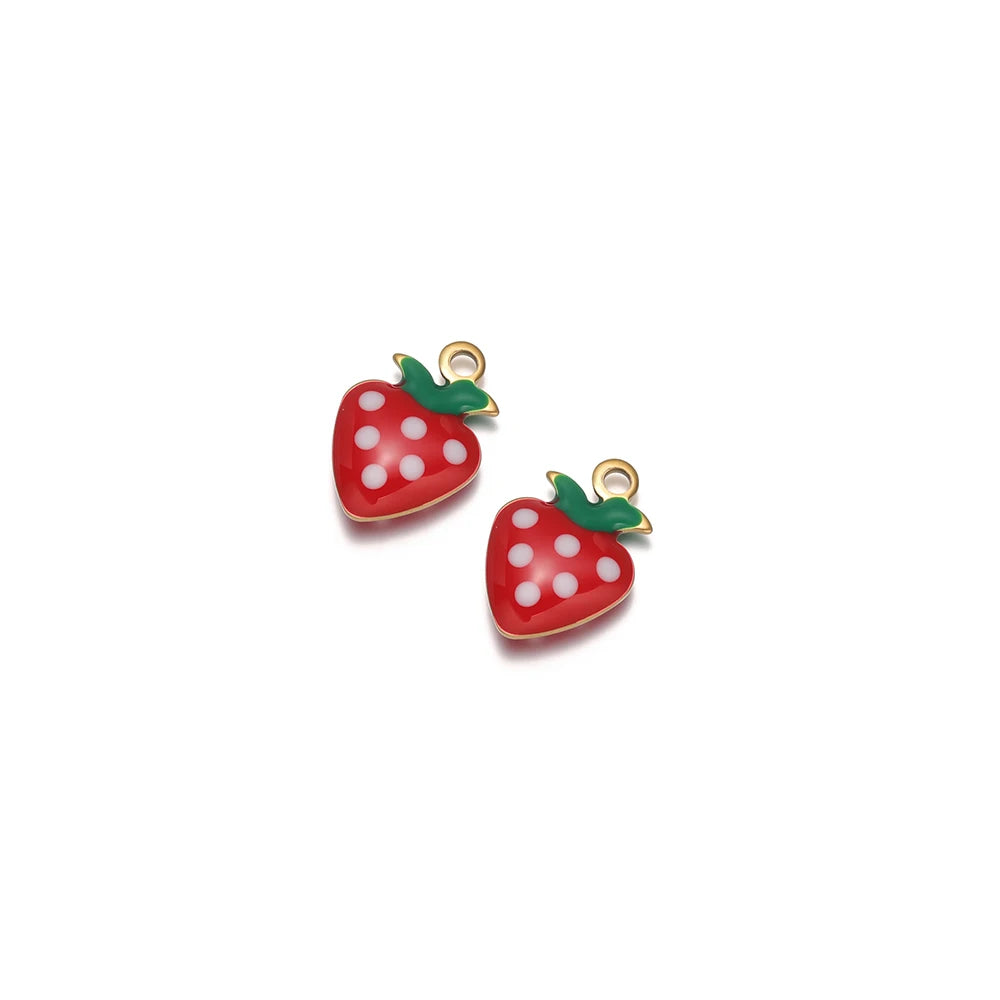 Red strawberry drop charms with white polka dots, green leaf tops, and gold-tone loops