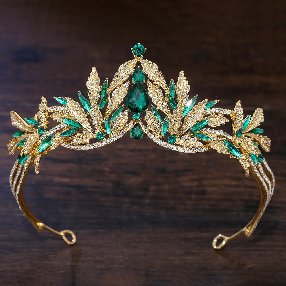 Gold-tone rhinestone diadem with teal-green leaf and floral crystals, curved tiara headband
