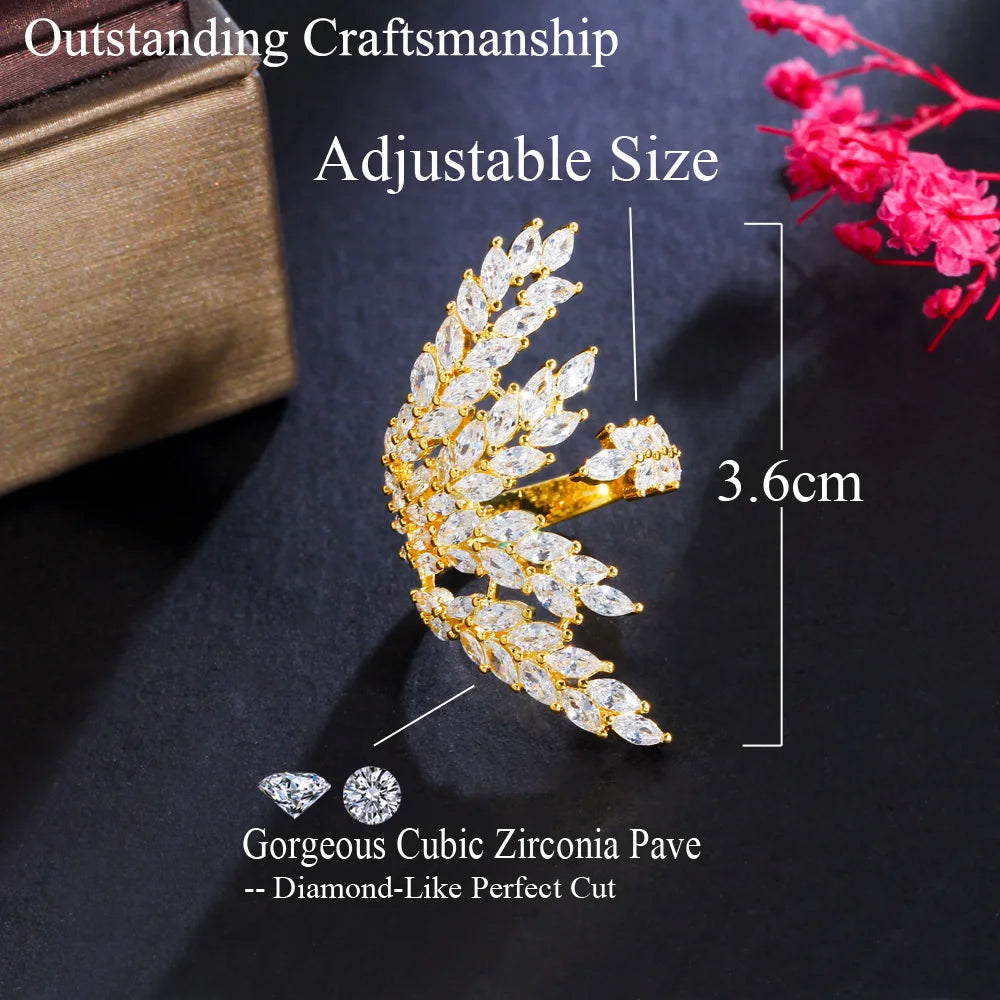 Gold-tone adjustable leaf ring with clear stones, shown with a 3.6 cm size marking