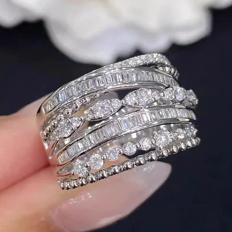 Silver cubic zirconia multi-band ring close-up with layered rows of round stones