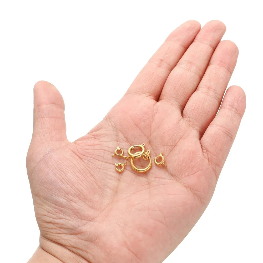 Gold spring clasp round connectors in palm, small hook ring closures (10 pcs)