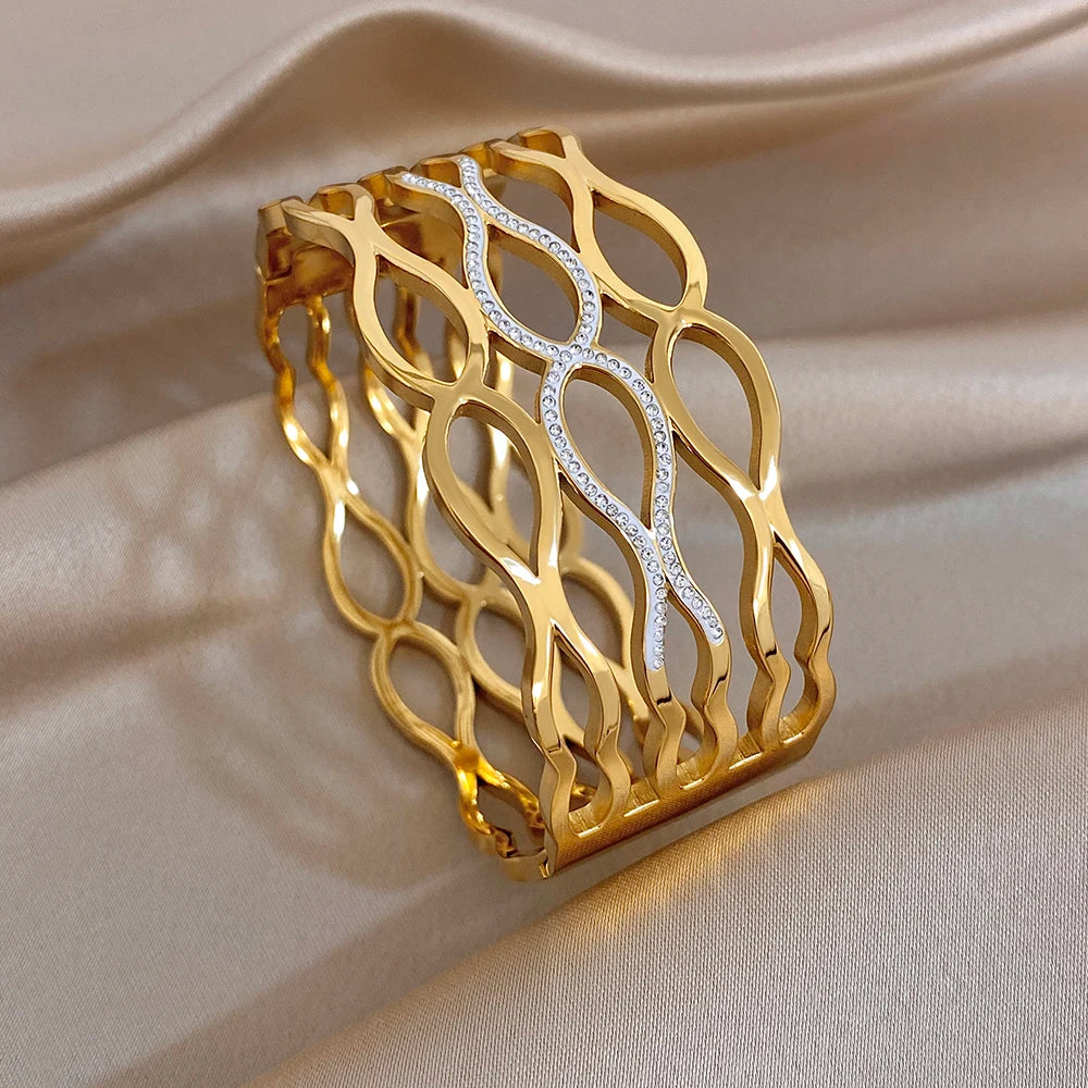 Gold-tone geometric cuff bracelet with oval-cut clear stones in an open lattice design