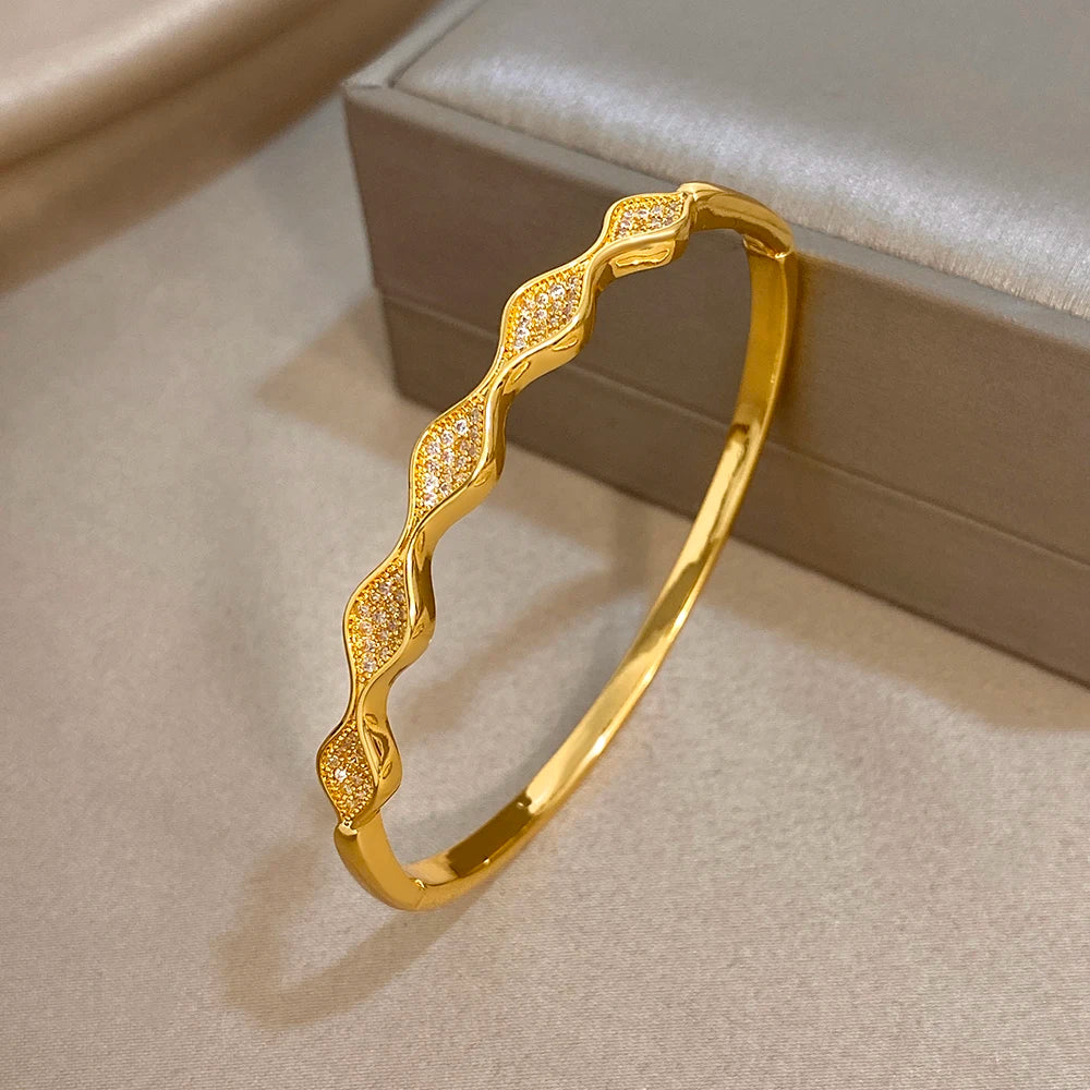 Gold-tone geometric wave cuff bangle bracelet with crystal-like stone details