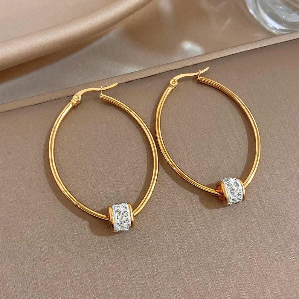 Gold-plated hoop earrings with clear rhinestone bead detailing on smooth round rings