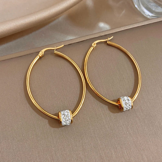 Gold-plated hoop earrings with clear rhinestone bead detailing on smooth round rings