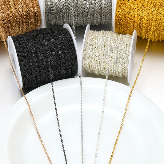 Thin stainless steel chain links on multiple spools in black, silver, rose gold, and gold