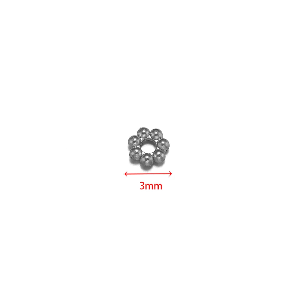 Steel flower spacer bead, single piece shown with 3mm size marker.