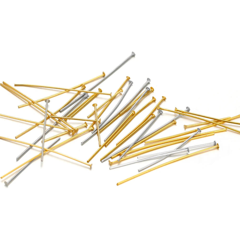 Heap of gold and silver T-eye pins with ball heads for jewelry crafting supplies