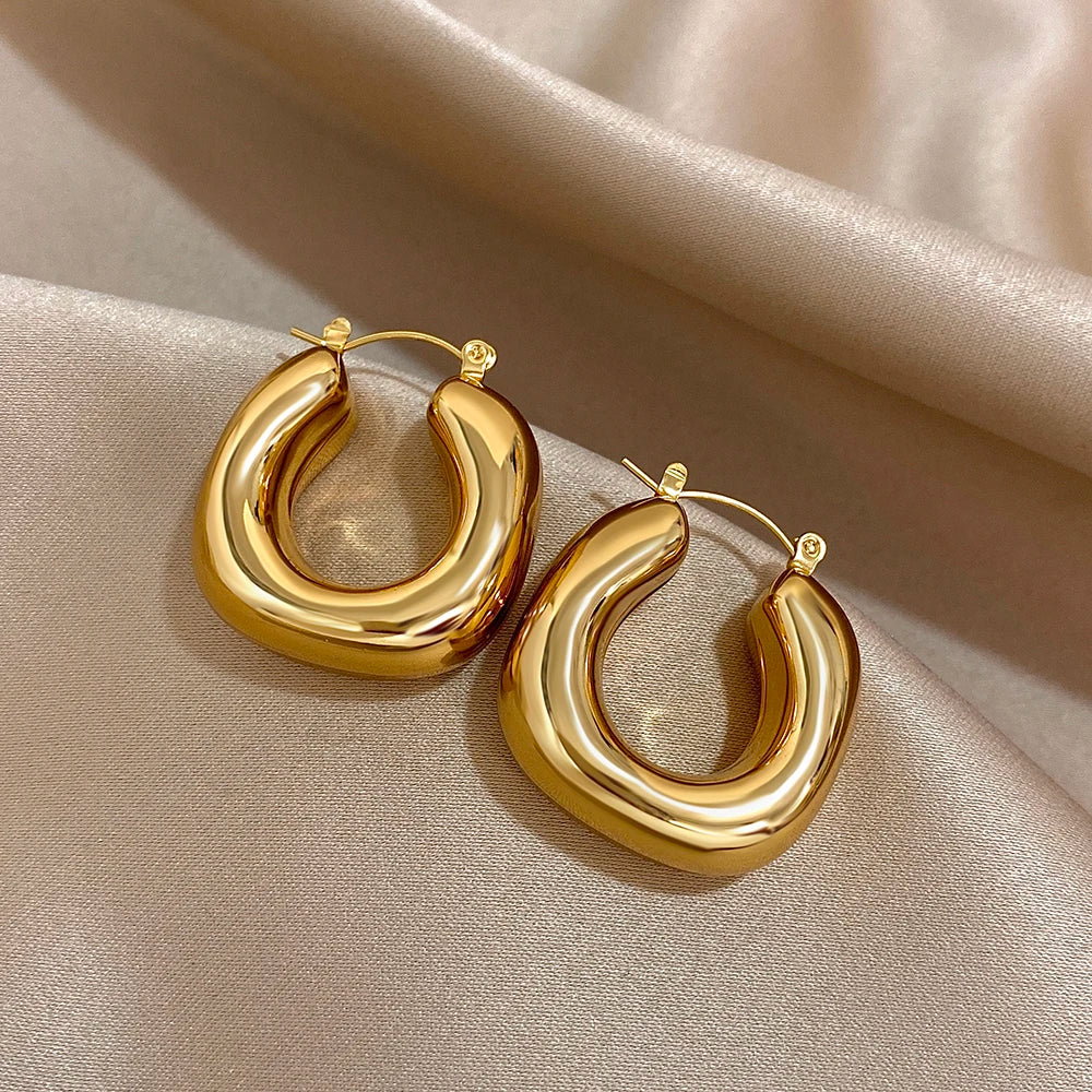 Pair of rounded gold-tone U-shaped earrings with slender hinged posts