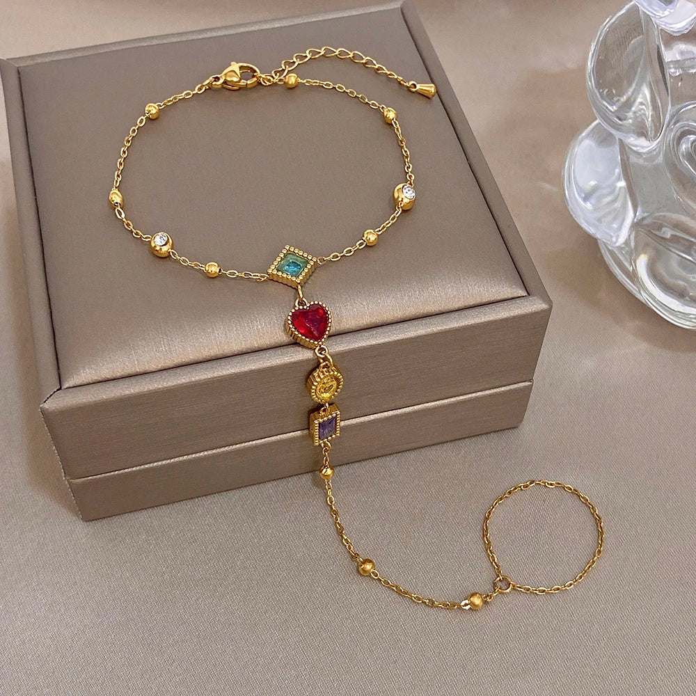 Gold-tone gemstone charm bracelet with dangling heart and multicolor square beads