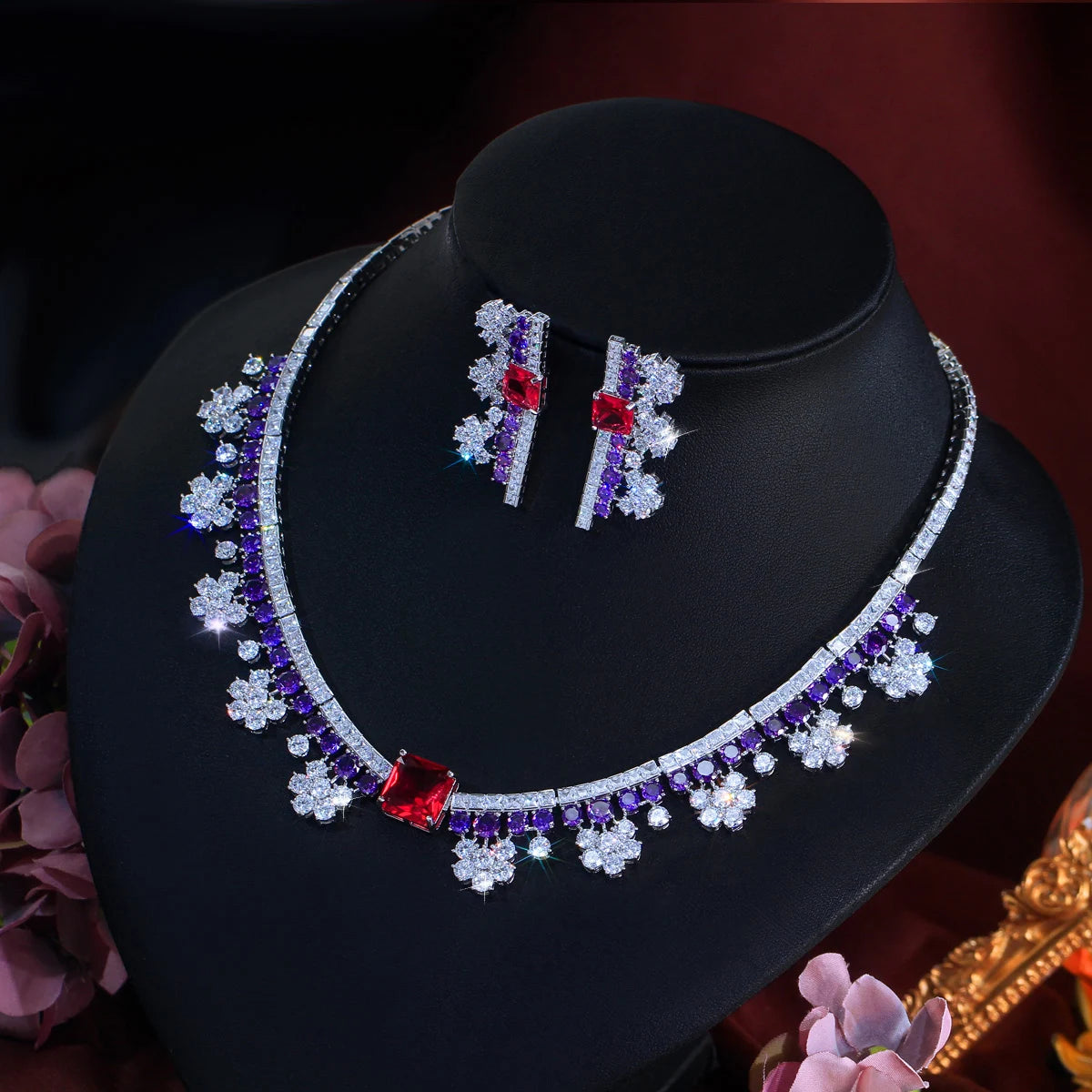 Multicolor crystal choker necklace and matching earrings on black jewelry display