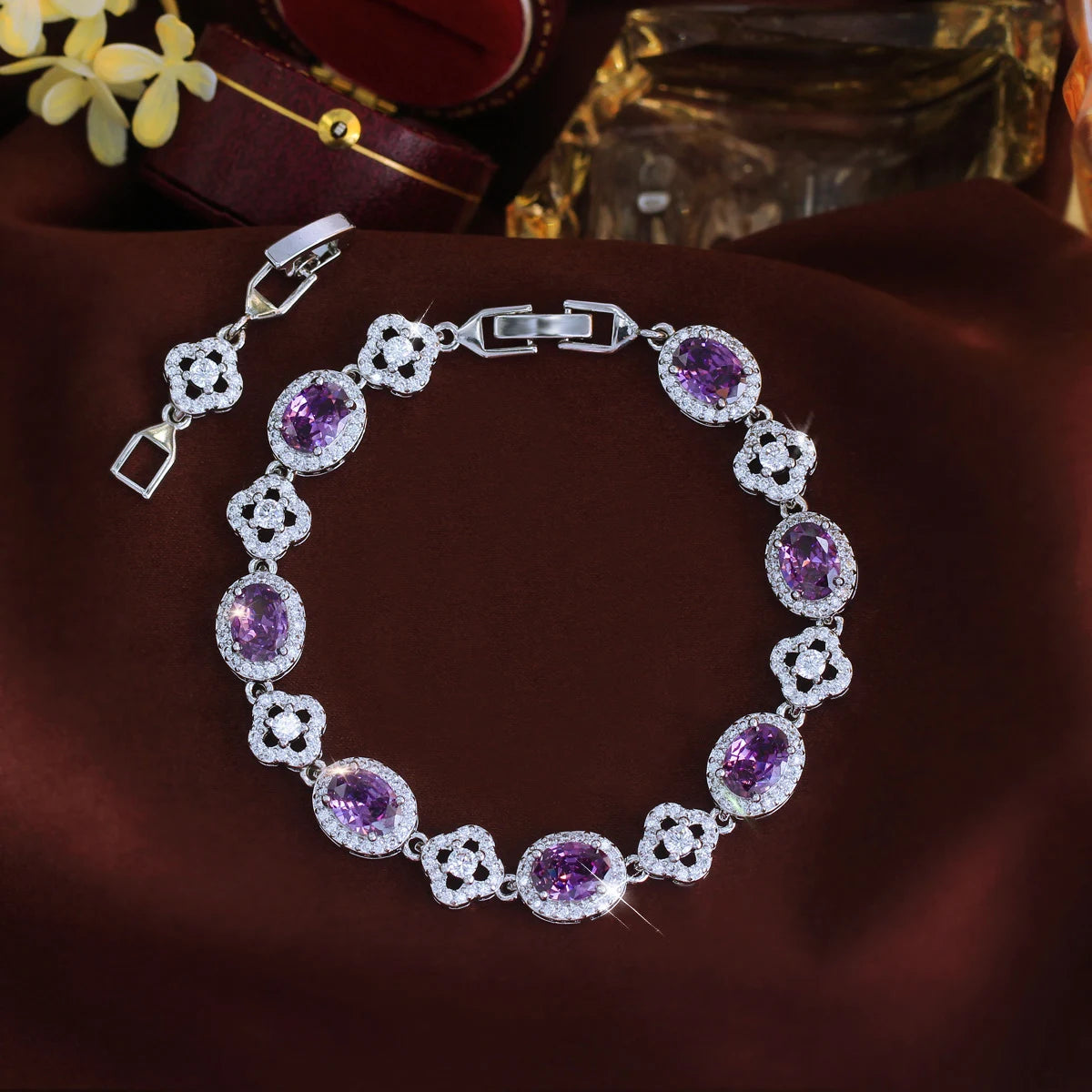 Purple oval crystal flower tennis bracelet arranged in a circle with clasp