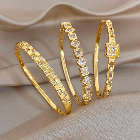 Gold-plated cuff bangles with square zirconia links, geometric center accents