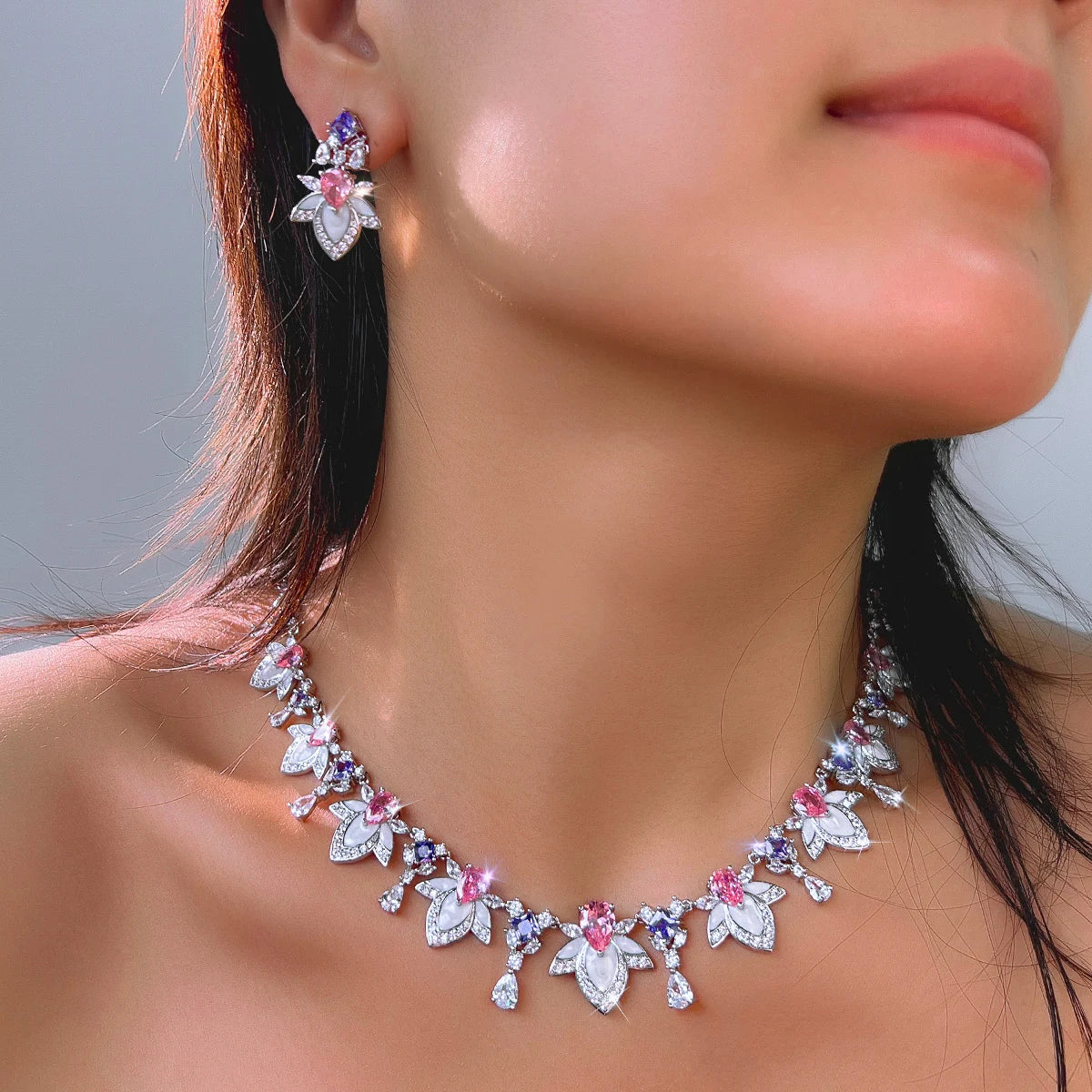 Multicolor cubic zirconia necklace and drop earring set worn, bow and leaf charm design