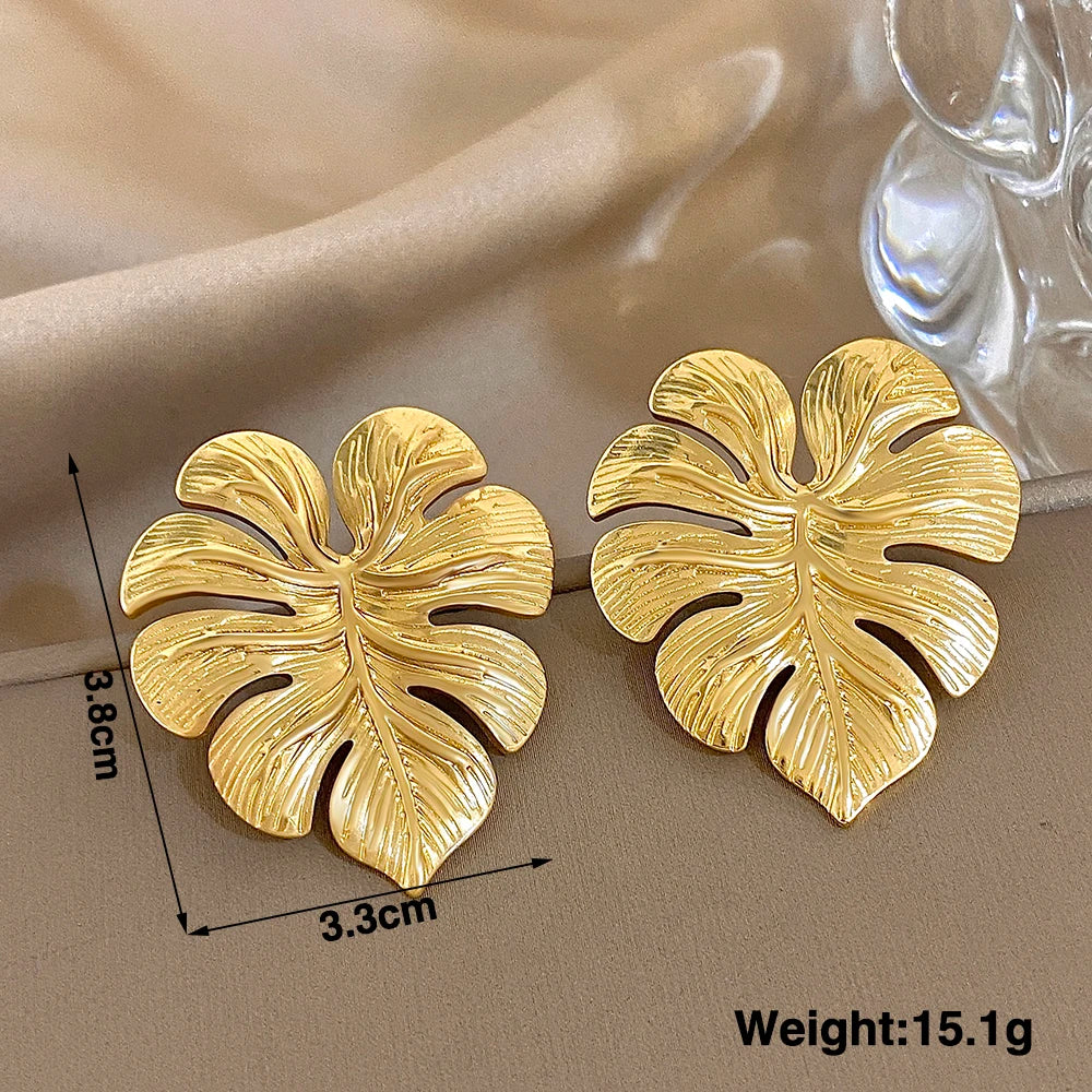 Gold leaf stud earrings, each about 3.3 by 3.8 cm