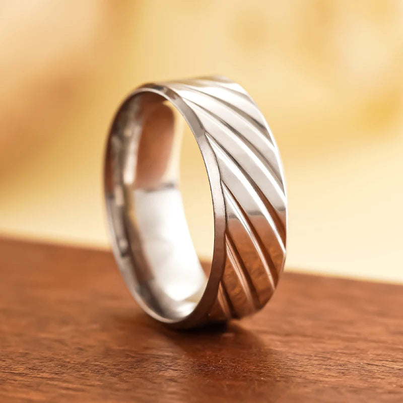 Stainless steel diagonal groove band ring with polished ridges and smooth inner edge
