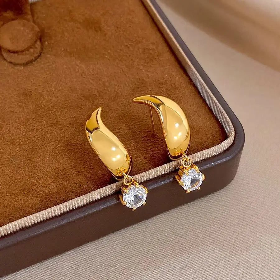 Gold-tone hoop earrings with clear round crystal dangles
