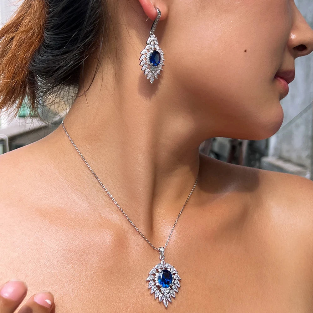 Blue oval CZ necklace and drop earring set worn on a model