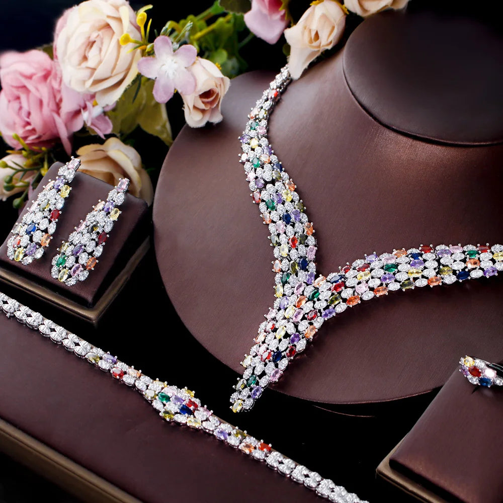 Multicolor cubic zirconia V-necklace with matching earrings on brown jewelry holders