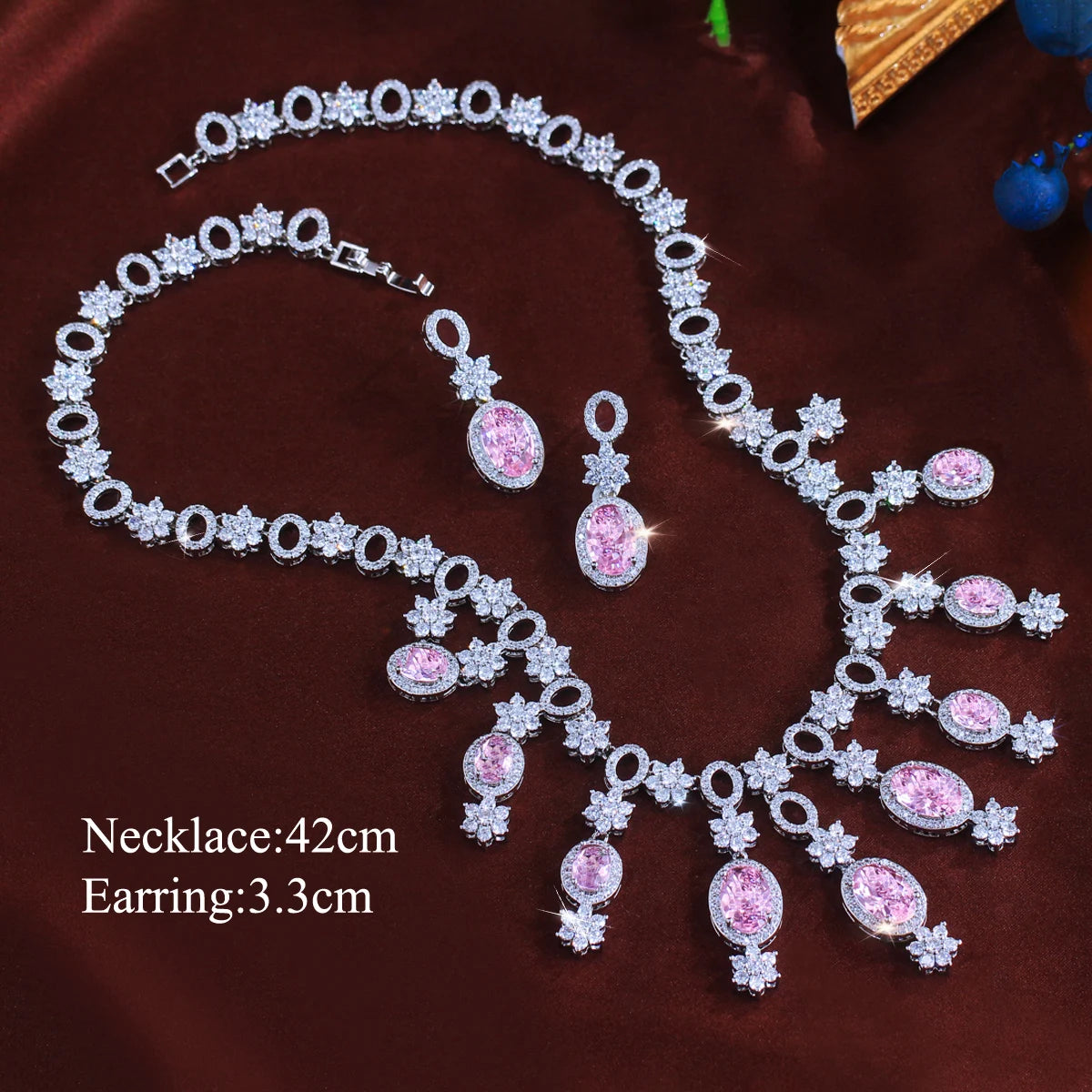 Pink oval stone necklace and earrings with floral crystal accents; necklace is 42 cm long