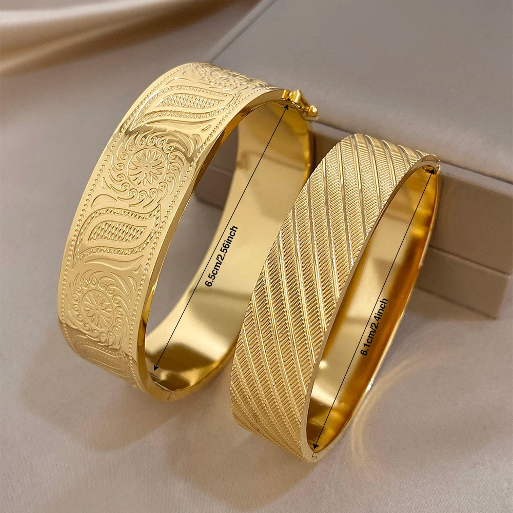 Gold-tone wide cuff bangles with inner engraving and engraved flower motifs