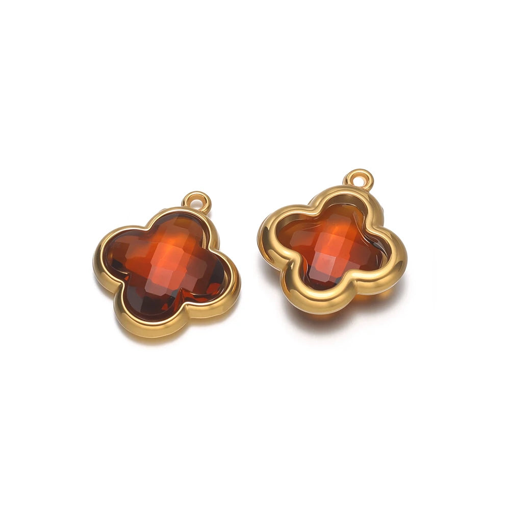 Four-leaf clover glass charm pendant with dark red-brown gem and gold-tone loop