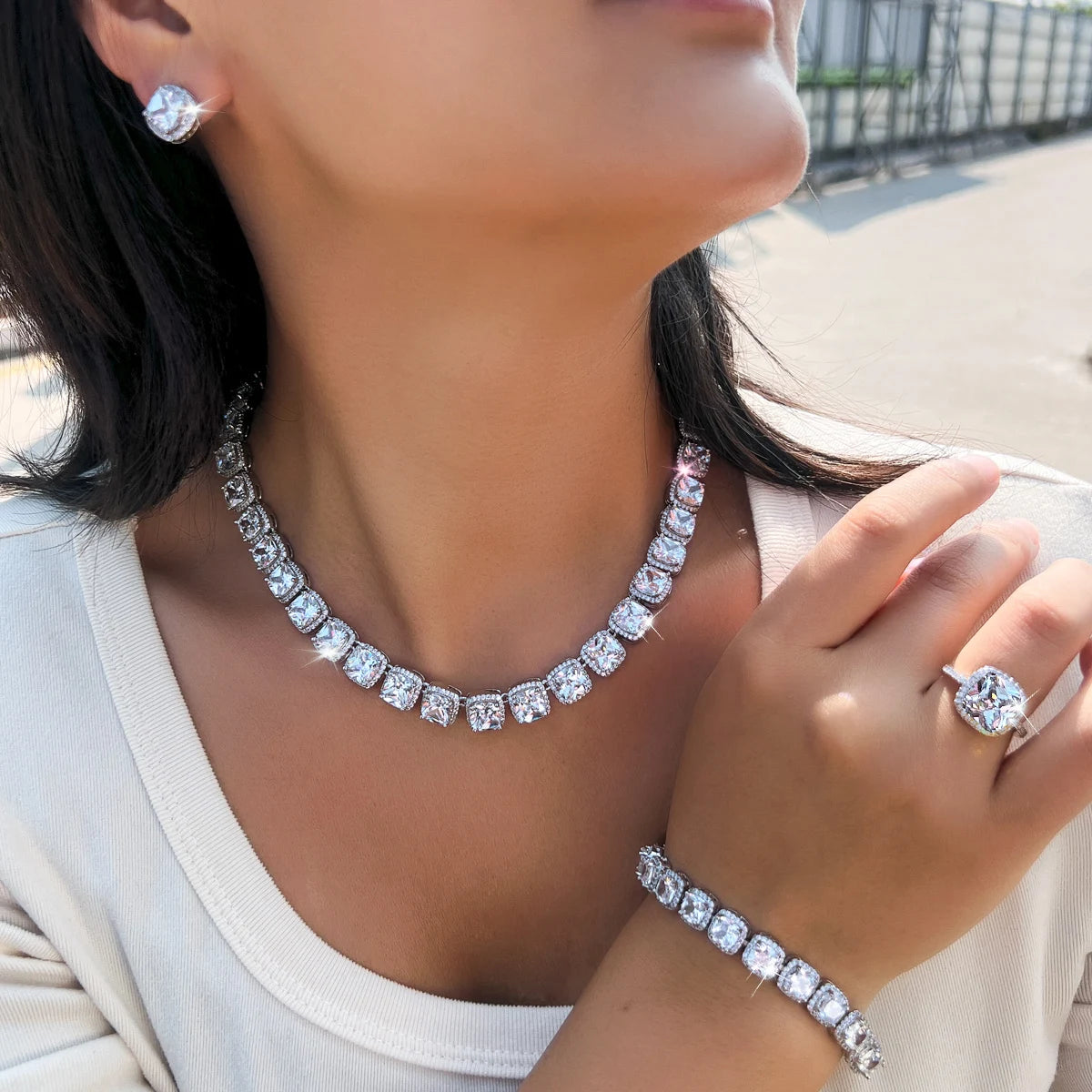 Silver-tone multicolor CZ necklace with matching bracelet and ring; stud earring visible