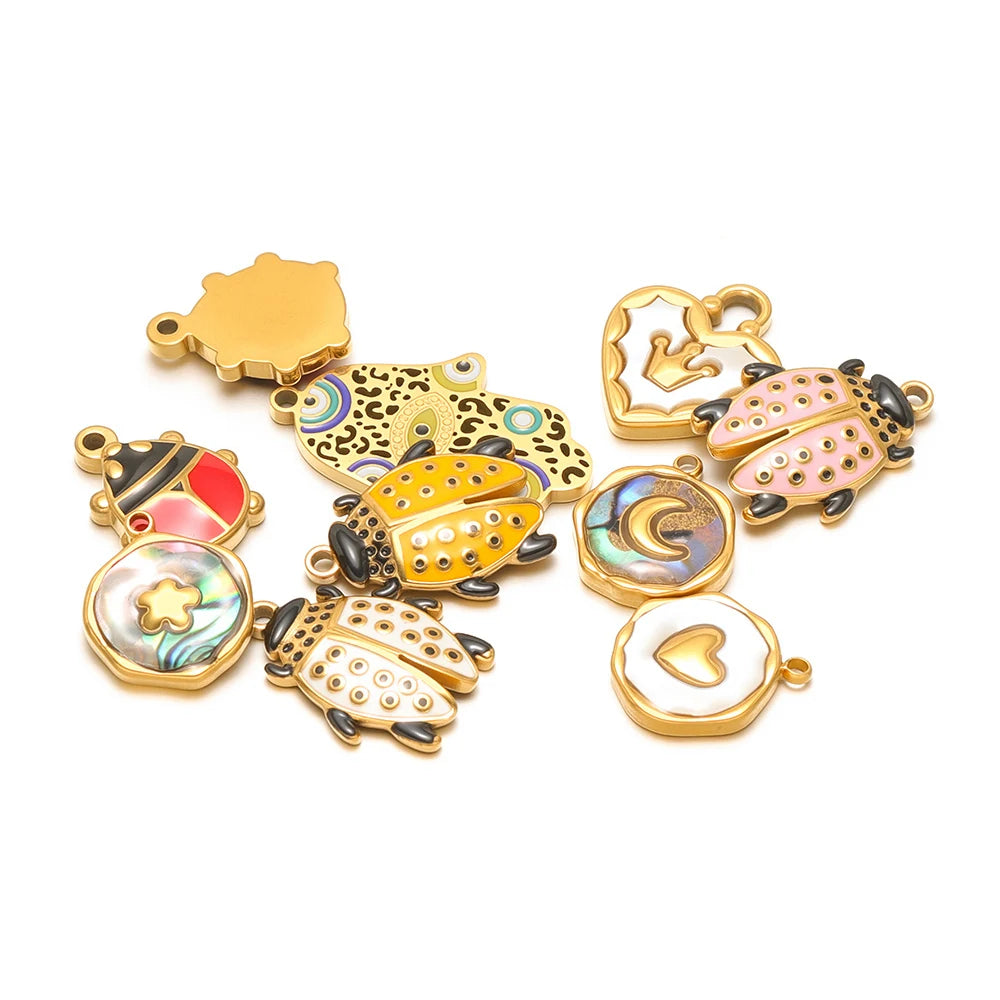 Mixed beetle shell charm pendants in gold-tone with red, blue, and iridescent accents.