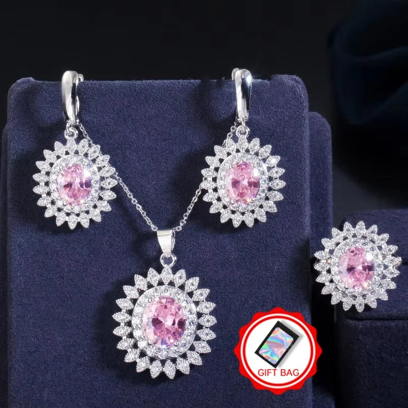 Silver-tone jewelry set with pink oval stones, floral halo earrings, pendant necklace, and ring