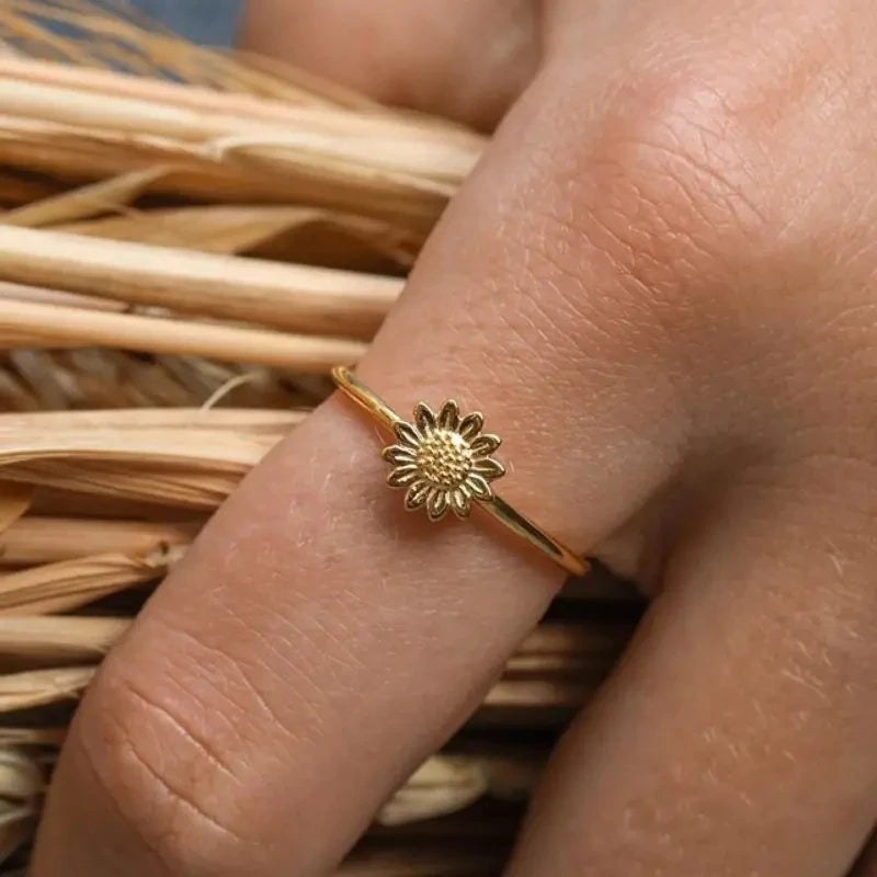 Gold sunflower dainty finger ring with textured flower face on slender band
