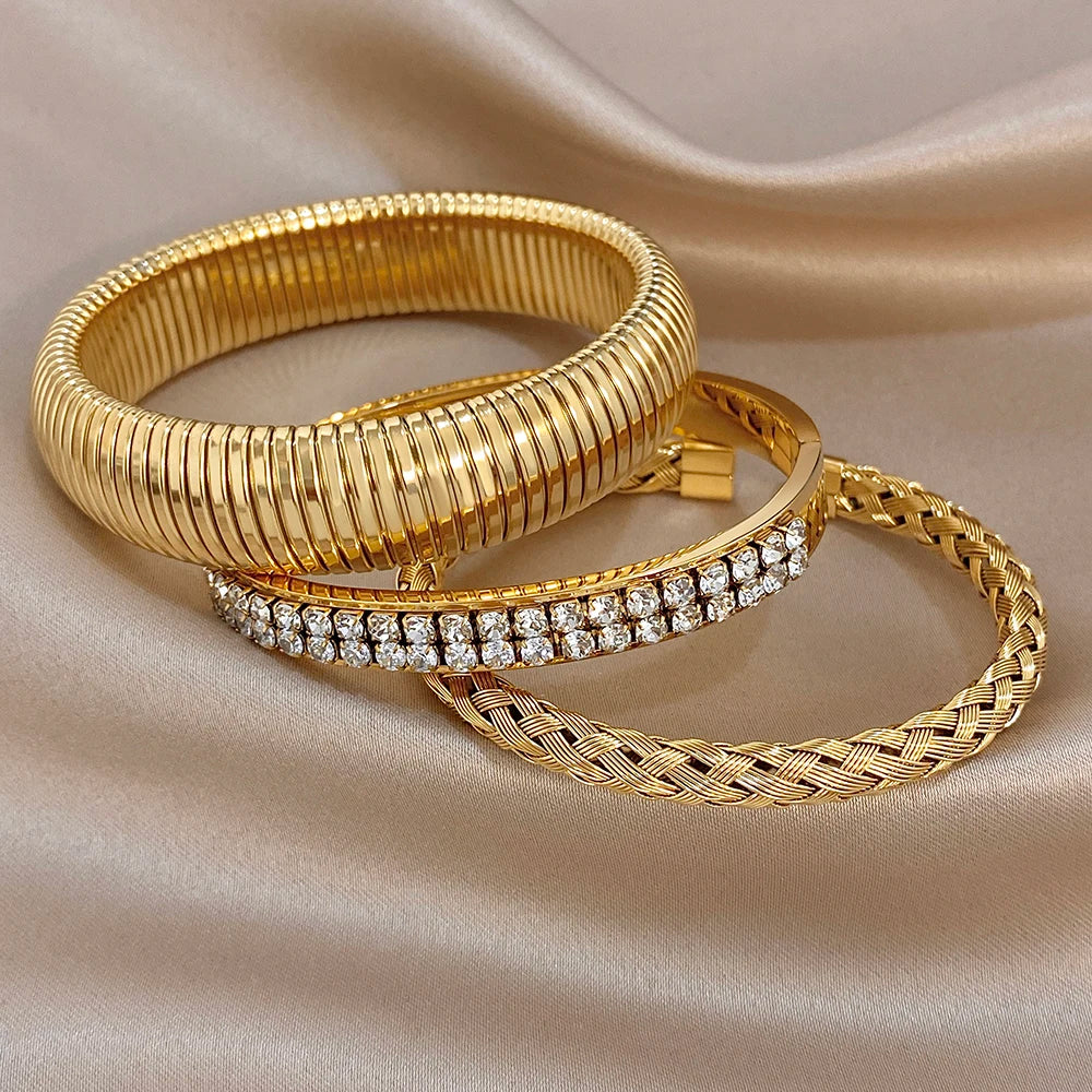 Gold-tone ribbed cuff bangle set with zircon pave bangle and braided bracelet