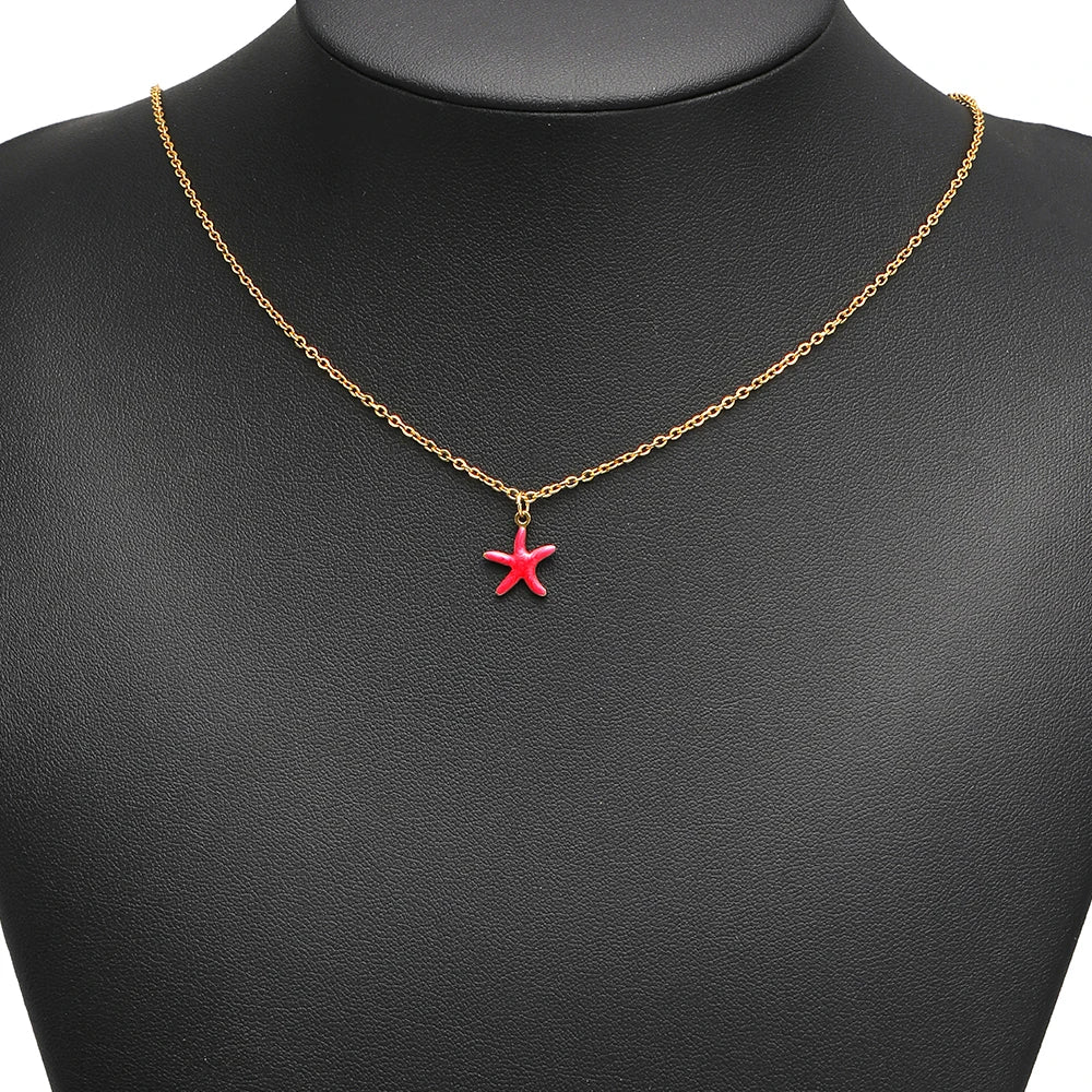 Starfish pendant charm on a gold chain necklace, red starfish with gold loop
