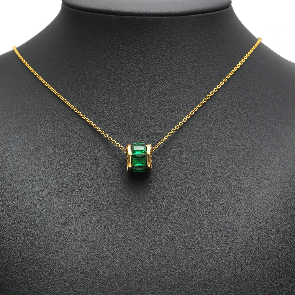 Gold-plated pendant necklace with a green crystal spacer bead and chain