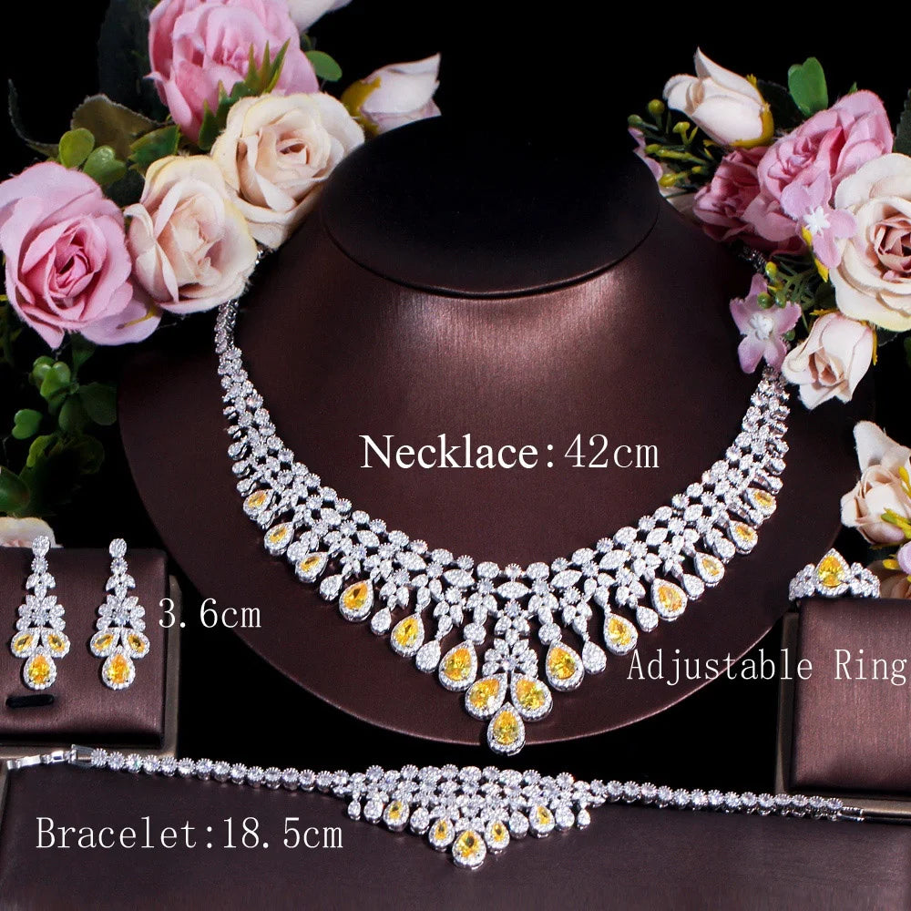 Crystal necklace, bracelet, and earrings display with yellow teardrop center stones