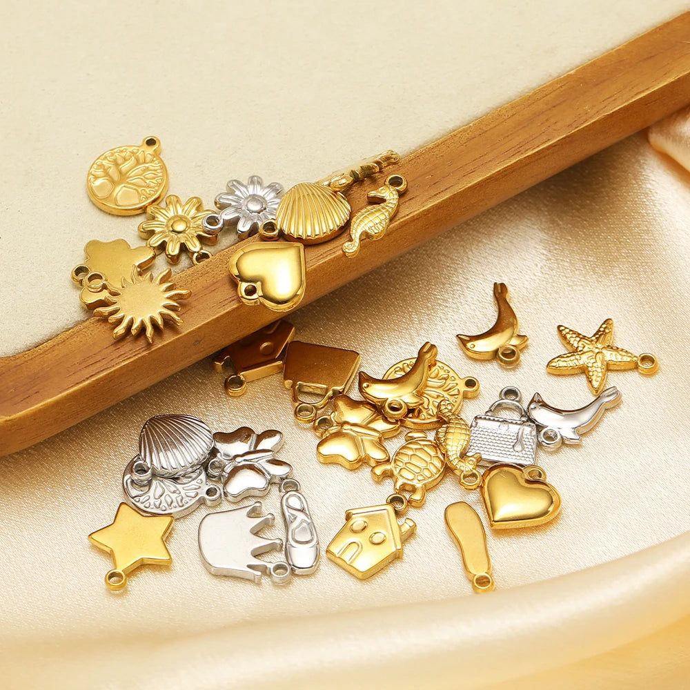 Gold and silver animal-themed stainless steel charms, star, shell, and heart pendants