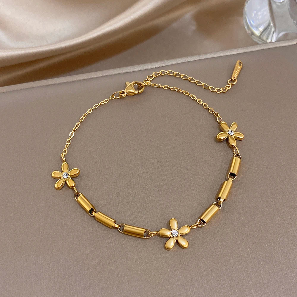 Gold-tone slim chain bracelet with flower charms and bar bead links