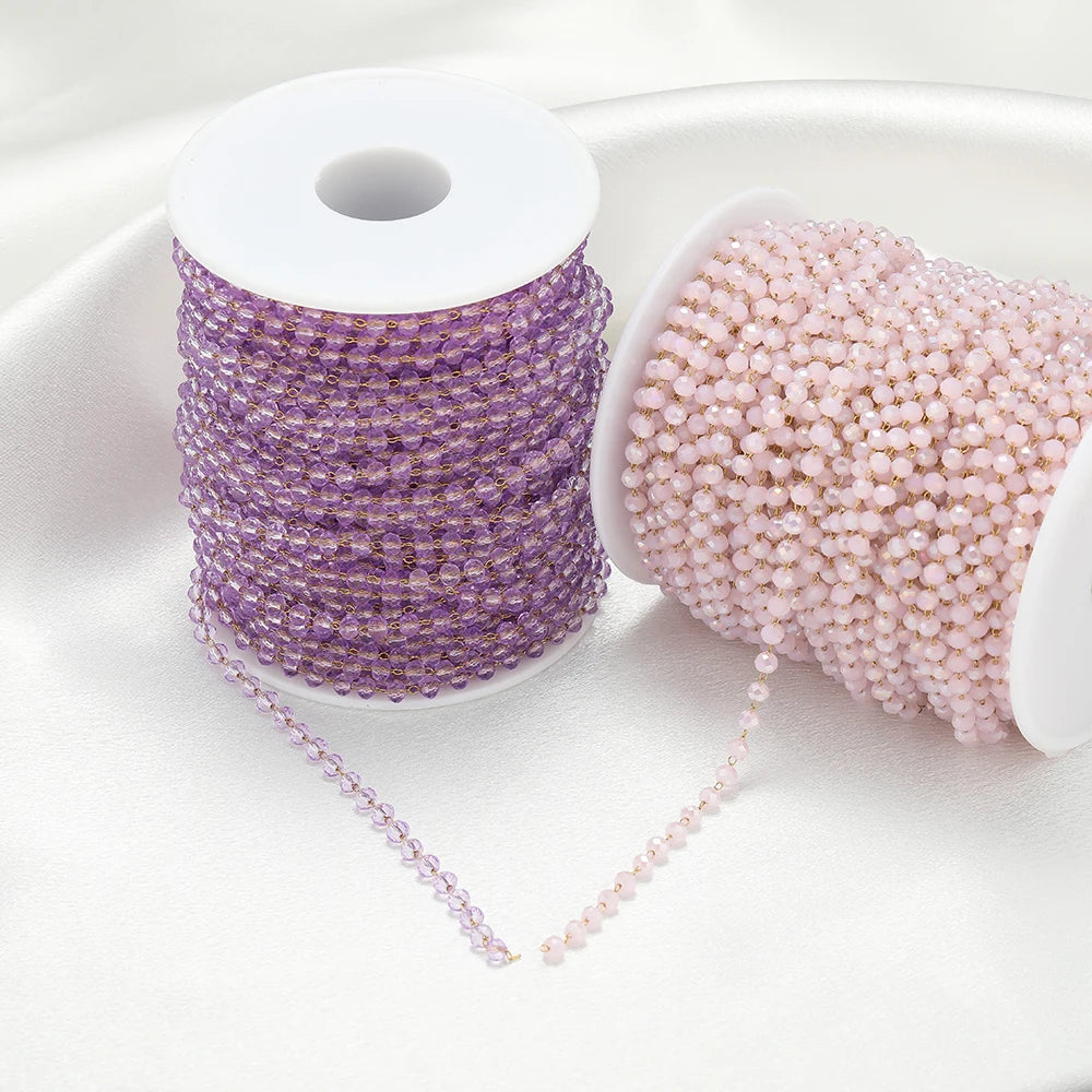 Lilac and blush faceted beaded chains on white spools with bead strands