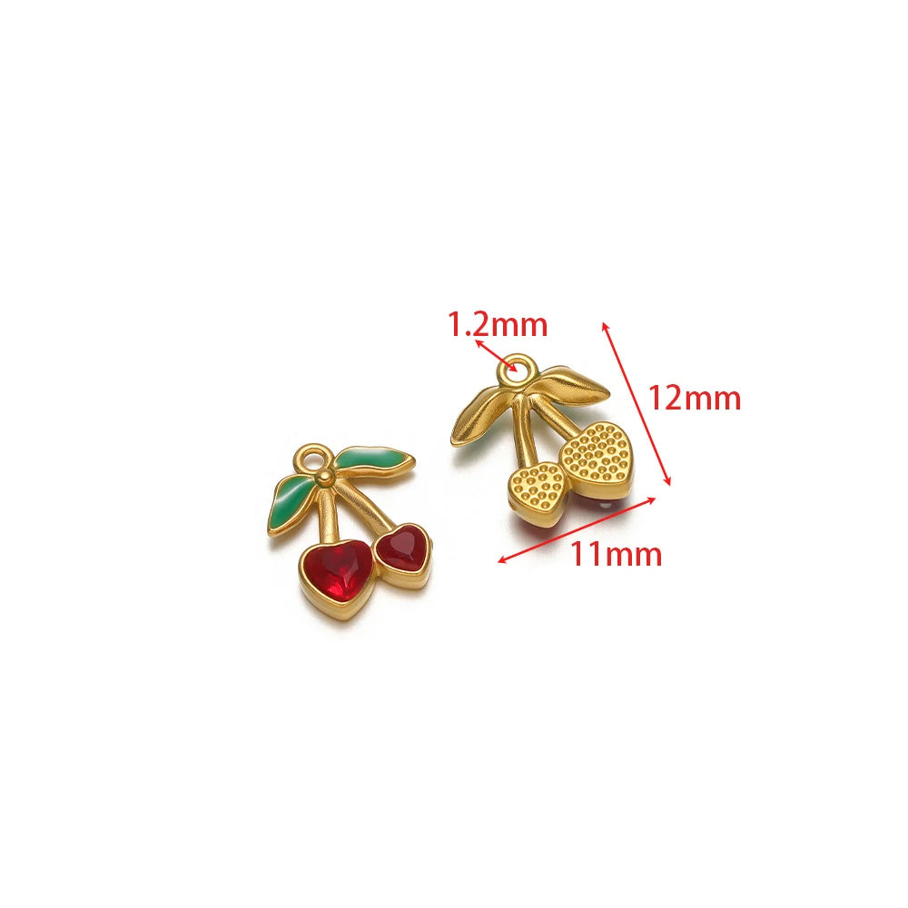 Gold cherry charm and red heart charm with green enamel leaf details