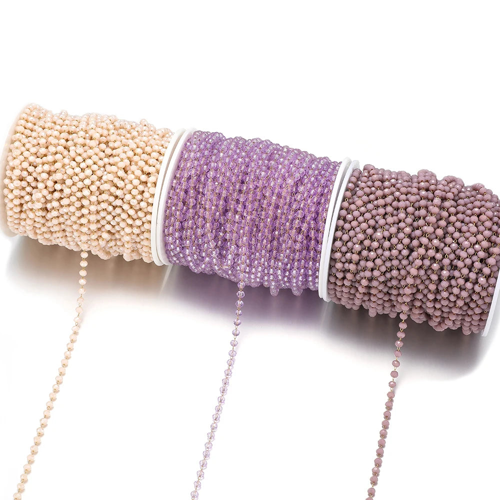 Faceted beaded chains on spools in beige, lavender, and mauve with dangling strands