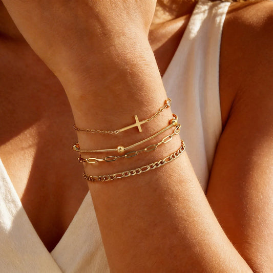 Gold cross charm and chain bracelet set, stackable on wrist with mixed link styles