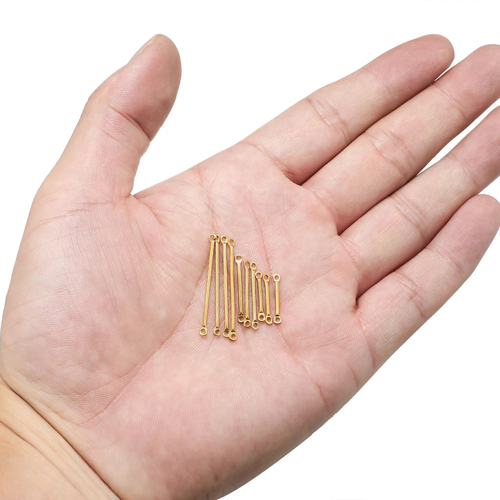 Gold wire bar link connector set held in palm, long sticks with end loop holes