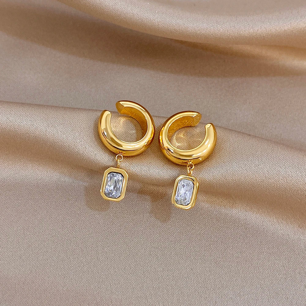 Gold-tone hoop ear clip earrings with square clear stone drop charms