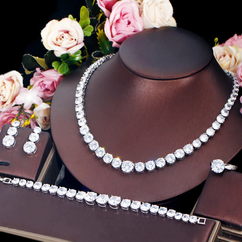Silver cubic zirconia tennis jewelry set with necklace, bracelet, and matching ring and earrings