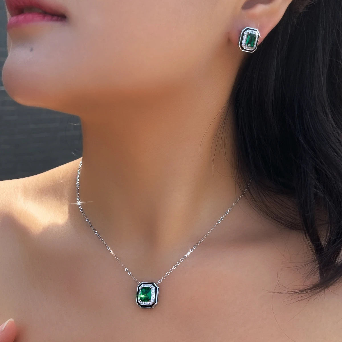 Green rectangular crystal necklace and matching stud earring worn together