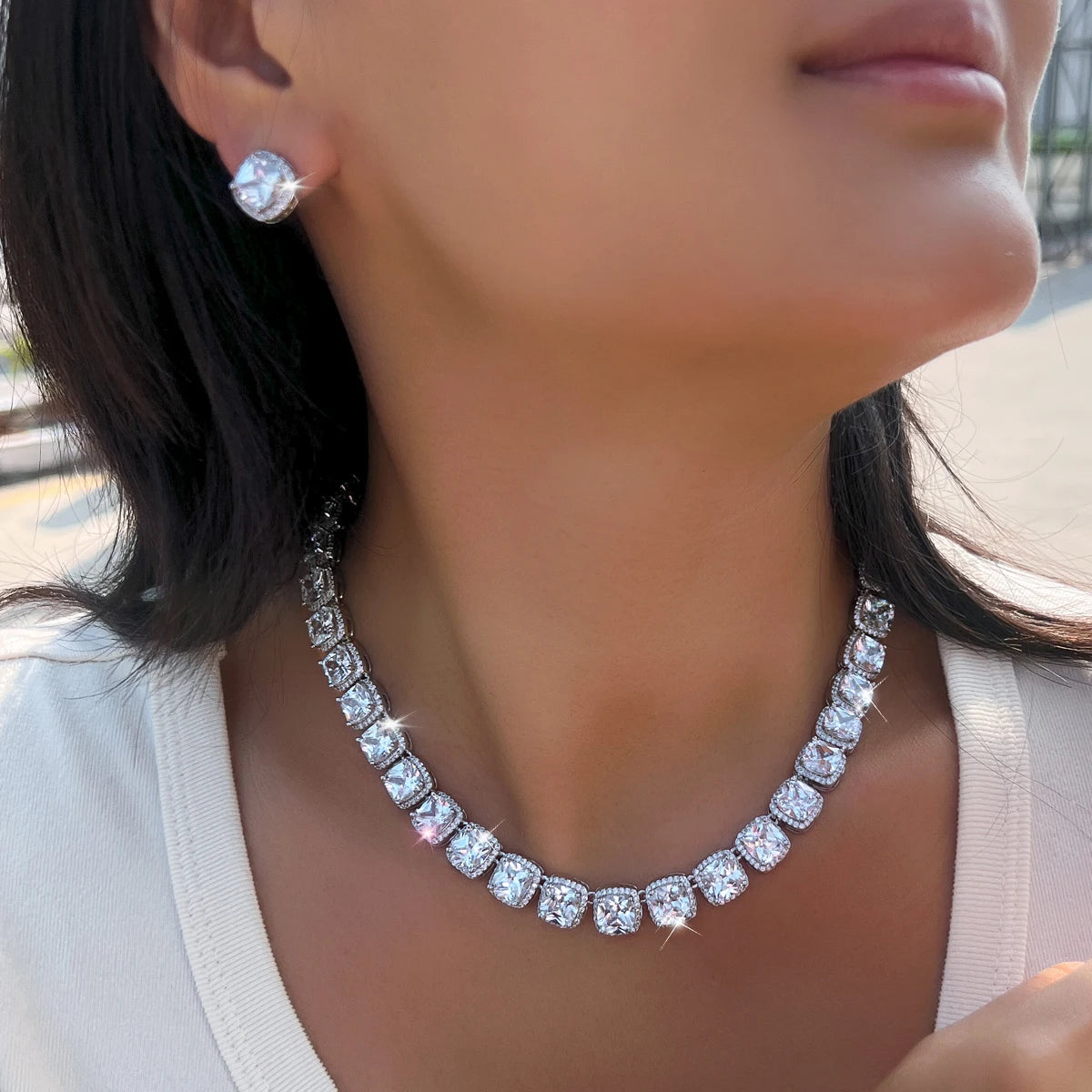 White zirconia necklace with matching round stud earrings worn together