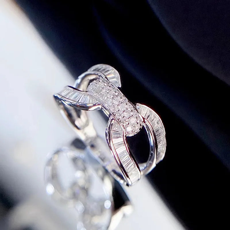 Women's modern fashion wedding ring with interlocking silver-toned band and pavé stones