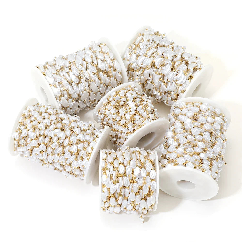 Spools of white artificial pearl chain with gold-tone metal for jewelry making