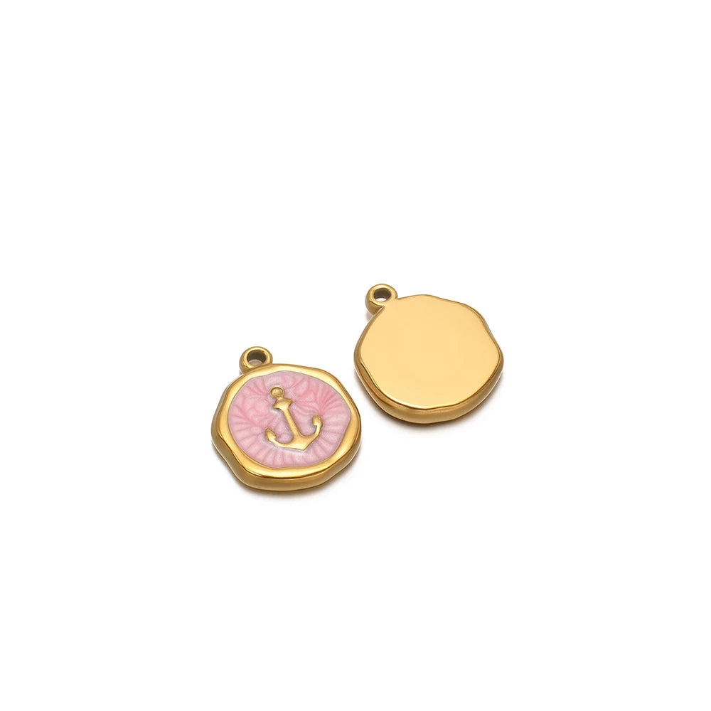 Two enamel charm pendants: gold blank disc and pink anchor icon with gold loop